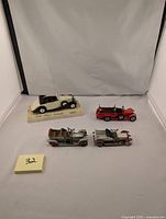 Four vintage diecast Rolls Royce model cars displayed together on white background including Solido Cabriolet, Lesney Silver Ghost missing parts, 1906 Silver Ghost, and 1920 Fire Engine.
