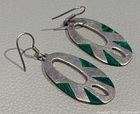 Pair of oval-shaped Mexico 925 silver earrings with green turquoise inlays on matte silver, showing front view and hooks.