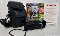Overview of Canon PowerShot S400 digital camera with original packaging and leather carrying case