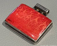 Close up image of rectangular coral pendant with natural coral pattern and silver frame