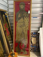 Full view of the framed brass rubbing showing the knight figure on red velvet background with gold frame.