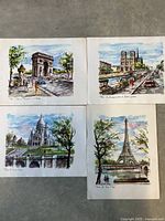 Four lithographs arranged together showing Paris scenes: Arc de Triomphe, Notre Dame, Sacré-Cœur, and Eiffel Tower.