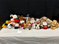 Front view of the collection of plush toys laid out against black backdrop.
