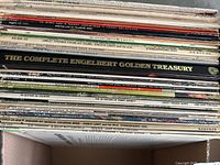 Stacks of vinyl record spines showing artist names and album titles including Englebert Humperdinck, soundtracks, and country albums.