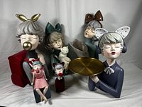 Six resin statuettes with girls holding different accessories including bubble gum, cat, bouquet, tray and mini statuettes of bubble blowing girls