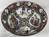Top-down view showing full interior design of the bowl with floral and court figure panels.