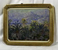 Full view of the framed artwork showing palm trees with mountains in the background, surrounded by ornate gold frame.