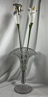 Full view of the crystal vase holding three faux Calla Lilies and one metal forged Calla Lily.