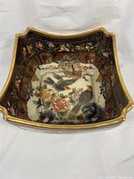 Front angled photo showing full interior decoration with birds, floral patterns and gold detailing.