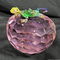 Faceted pink crystal orb with multicolored glass chameleon figurine on top against black background showing overall condition and dimensions