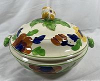 Side view of the tureen with lid showing floral hand painted design and handles