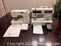 Two sewing machines side by side with manuals and foot pedals on table