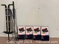 Photo showing a black and green pogo stick next to multiple golf clubs leaning against a wall.