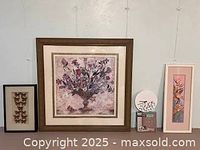 Wide shot of the lot showing the large bouquet print in center, framed Monarch butterflies on left, and part of a clock on right.