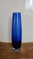 Front view of the tall blue cobalt glass vase showing gradient blue color and clear base