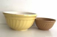 Side view of the two mixing bowls highlighting the swirl pattern and rolled rim.