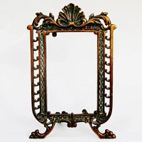 Full front view of the ornate copper plated antique photo frame showing intricate design with shell motif and scroll feet.