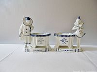 Front view of pair, showing full profiles and attached jars with blue decoration