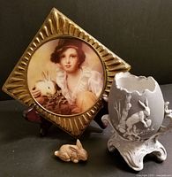 Photo displaying all three items including brass framed child's rabbit portrait, small Wade rabbit figurine, and jasperware egg with rabbit in relief
