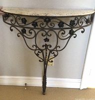 Front view of Italian half circle wall-mounted credenza with wrought iron scroll base and marble top