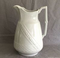 Full view of large white ironstone jug showing the shape and handle