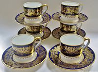 Set of six demitasse cups and saucers arranged in pairs showing cobalt blue and gold decoration