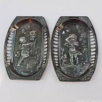 Pair of antique silver plate calling card trays with putti and mythological reliefs, angled sides with cutout ovals