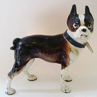 Side view of the cast iron Boston Terrier door stop showing the full body and paint condition.