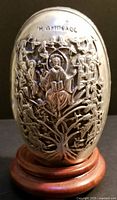 Front side of silver egg displaying Jesus in center of Tree of Life with 12 disciples on branches and Greek inscription