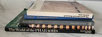 Side view of five stacked books on ancient Egypt and pharaohs, titles visible on spines.