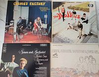 Four vinyl LP album covers: Creedence Clearwater Revival 'Cosmo's Factory,' The Hollies 'The Hits,' Simon & Garfunkel 'Parsley, Sage, Rosemary and Thyme,' and The Monkees 'Pisces, Aquarius, Capricorn & Jones Ltd'