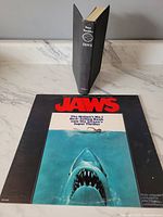 Original first pressing vinyl soundtrack of the Jaws movie with iconic shark cover art.