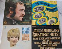 Front covers of the four vinyl records laid out, showing Richard Harris, 24 Solid Hits, Petula Clark, and Jay and the Americans albums.