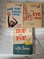 Front covers of all three books: "Hand, Hand, Fingers, Thumb," "The Eye Book," and "Hop on Pop." All are vintage hardcover children's books with Dr. Seuss related illustrations and titles.