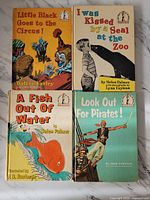 Front covers of the four hardcover children's books showing colorful illustrated designs and titles