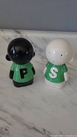 Front view of vintage Knorr salt and pepper shakers, black figure marked P and white figure marked S.