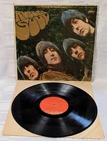 Front cover of Rubber Soul album with Beatles members and large stylized title text.