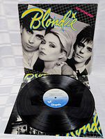 Photo showing vinyl record partially removed from album cover, highlighting the blue Chrysalis label on the vinyl and wear on cover edges.