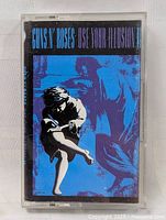 Front cover of the cassette showing blue and black image and album title.