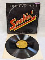 Front of album cover showing title 'Smokin' by Humble Pie with some wear and a small price sticker