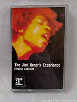 Front cover of Jimi Hendrix Electric Ladyland cassette tape featuring a colorized close-up of Jimi Hendrix's face.