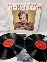 Photo showing both black vinyl LPs with red Columbia Records labels and original album cover featuring image of Johnny Cash.