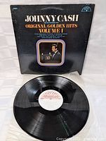 Front cover of Johnny Cash Original Golden Hits Volume 1 vinyl LP showing album title and photo of Johnny Cash holding a candle.