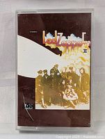 Front of cassette case showing Led Zeppelin II album cover artwork with group photo and title.