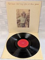 Vinyl record shown with red center label, clean and glossy surface.