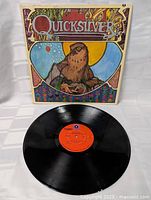 Front cover of vintage Quicksilver Messenger Service LP with colorful bird illustration and band title