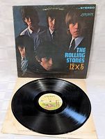 Front cover of The Rolling Stones 12 X 5 vinyl LP record showing band members and album title with visible wear.