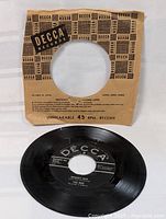 Photo of The Who "Happy Jack" 45 RPM vinyl record with original brown Decca record sleeve marked unbreakable 45 RPM.