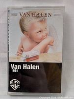Front of cassette tape case showing Van Halen 1984 album cover with cherub image.
