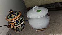 Photo of the two jars, colorful Mezzana biscuit jar and white ironstone slop bucket side by side.